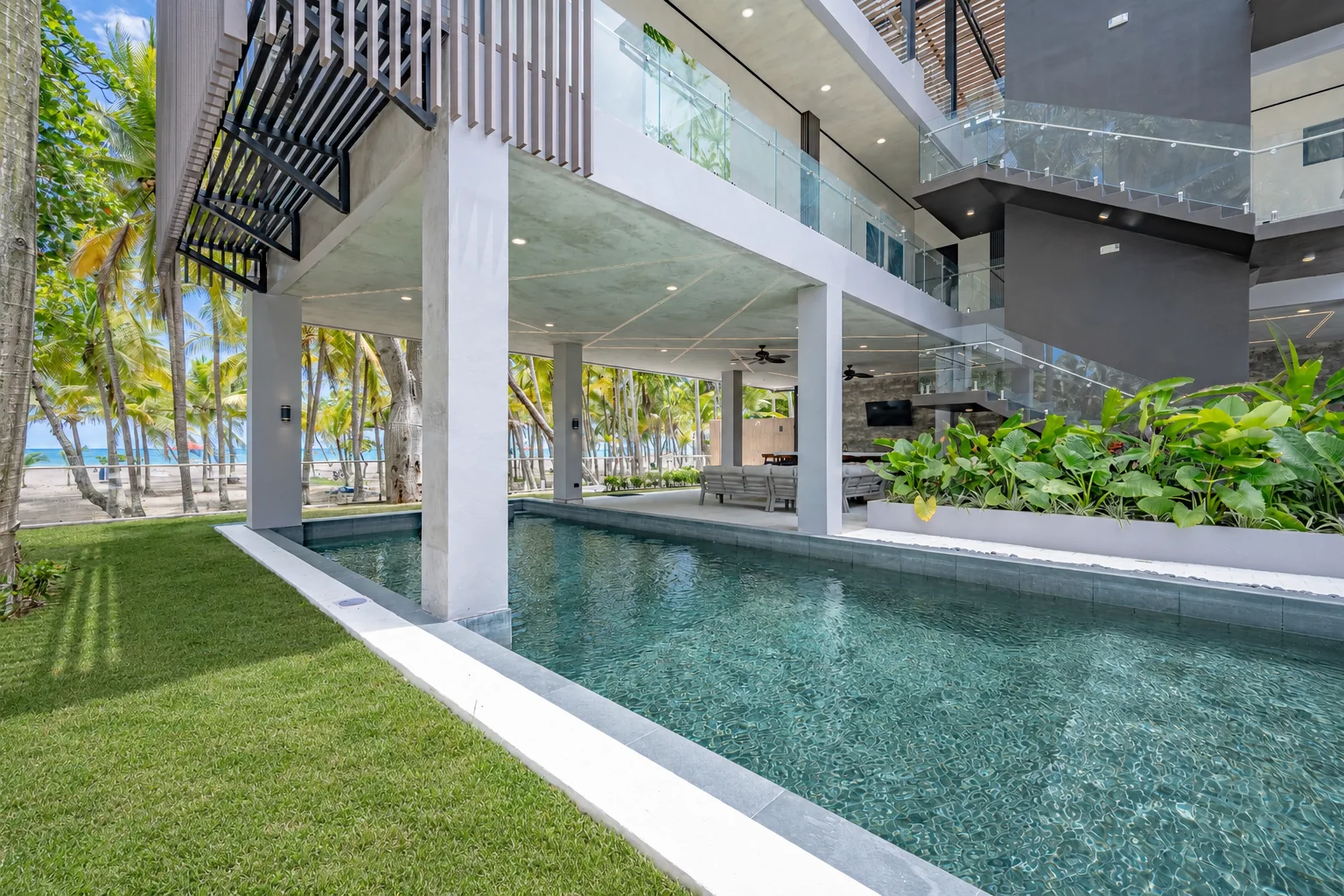 Pool edge and lawn with the beach beyond