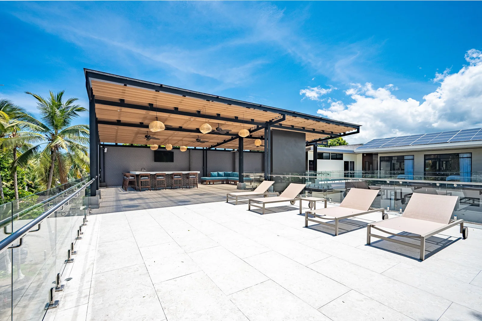 Rooftop sun deck with loungers overlooking the palms