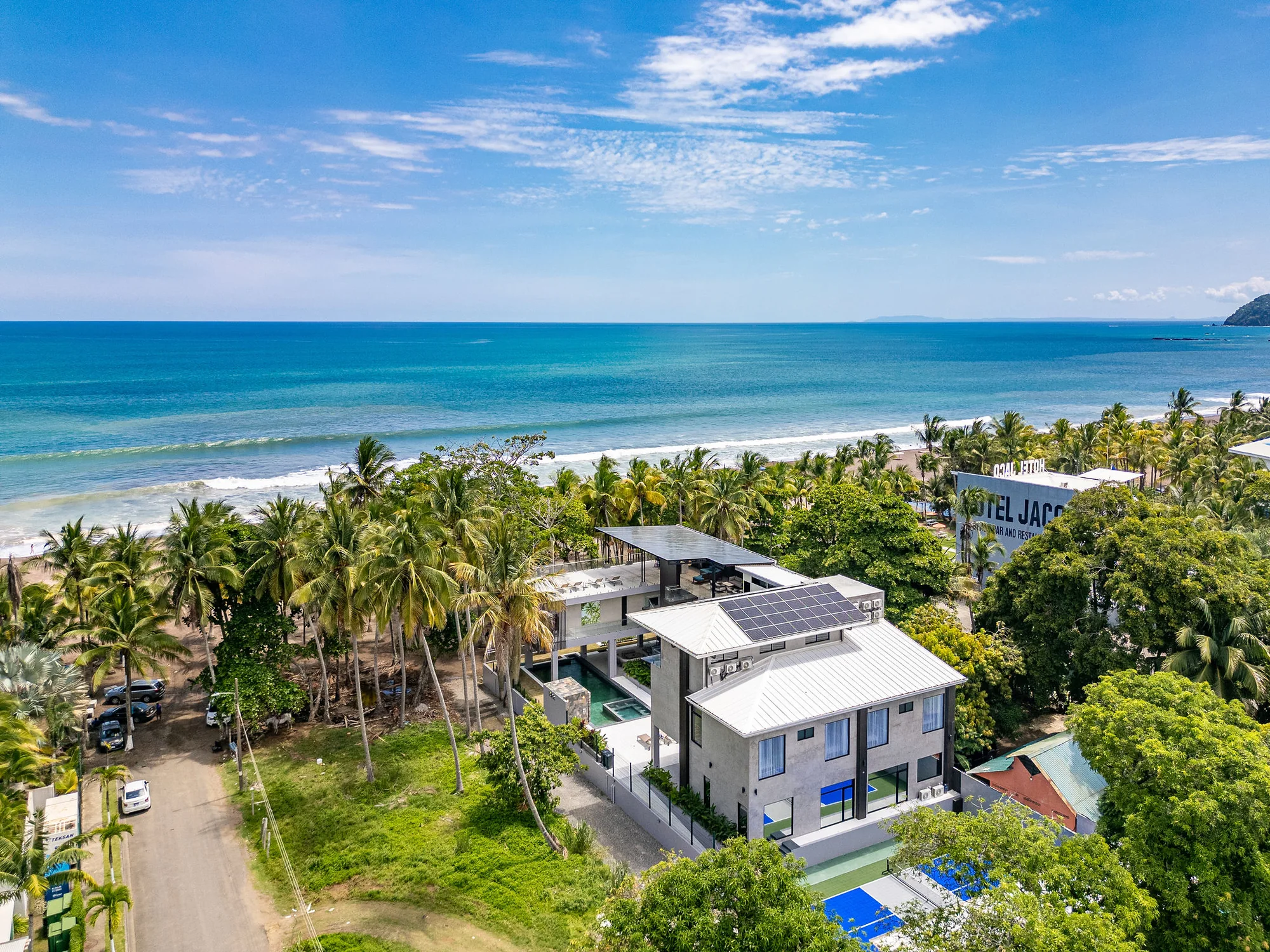 Aerial view of Casa Las Palmas, the palm grove and the Pacific surf at Jaco