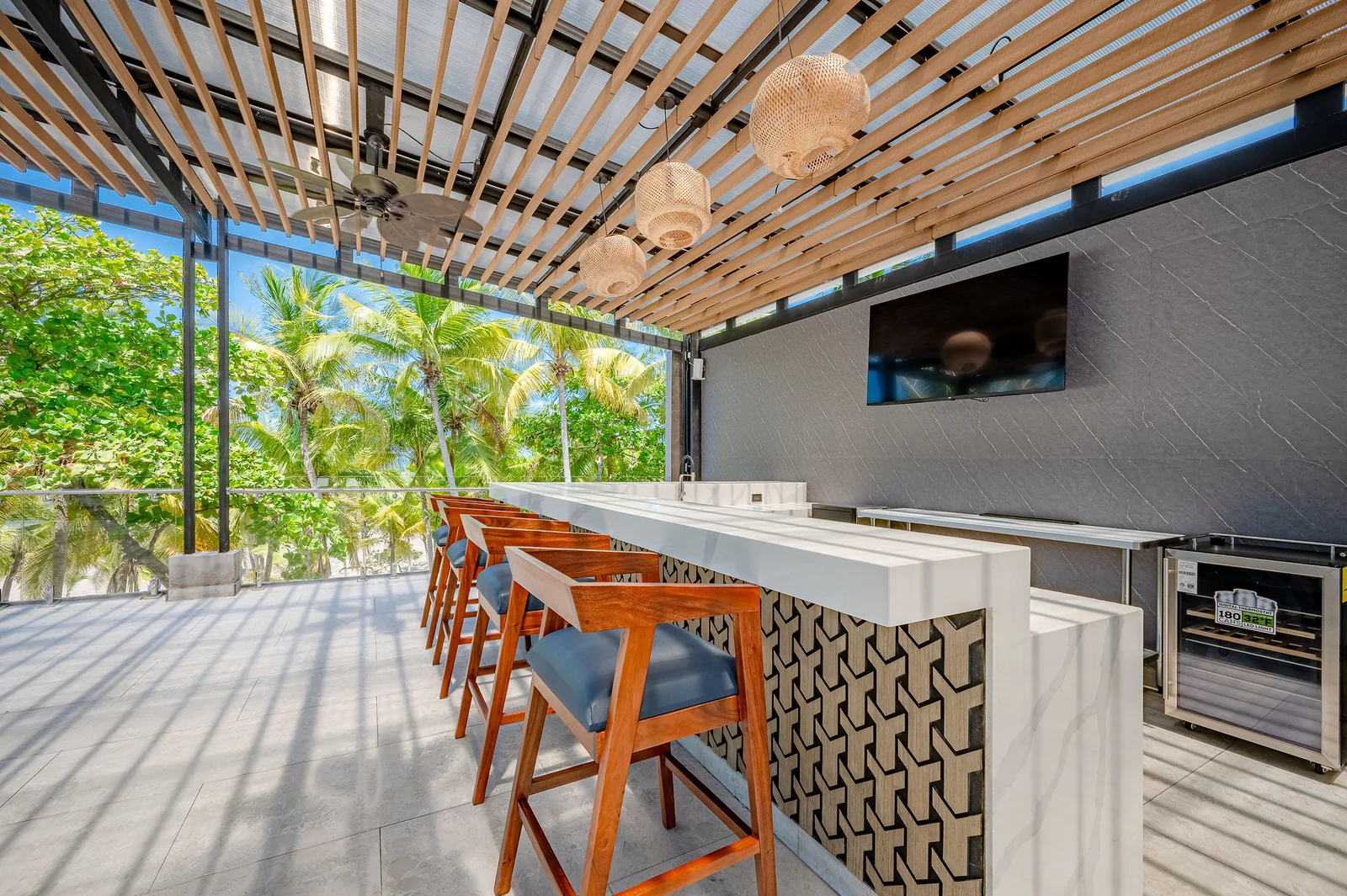 Rooftop bar with stools beneath the pergola